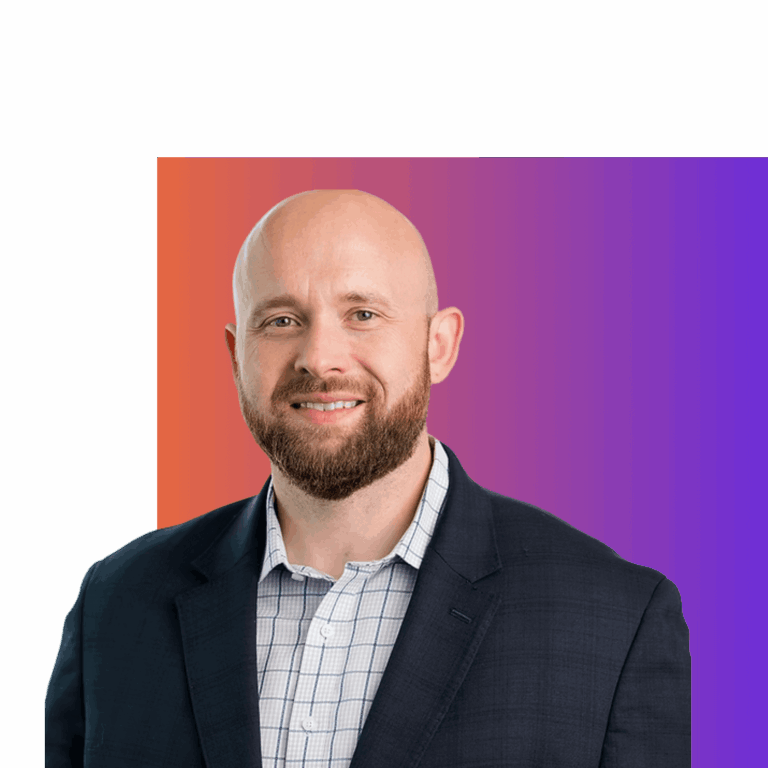 Portrait of a smiling man with a beard in a suit against a vibrant purple and orange gradient background.